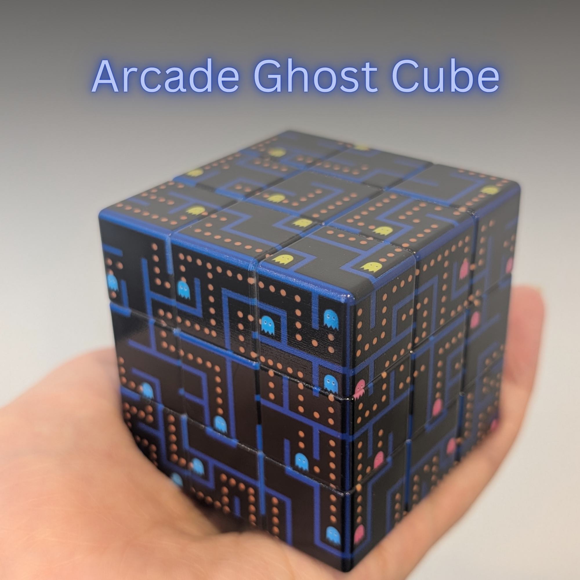 Arcade Ghost Cube (3x3x3) design held in a hand against a neutral background