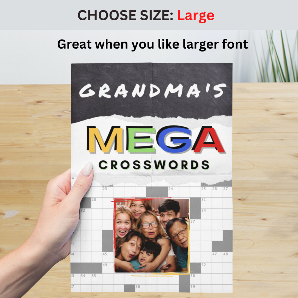 Large size book titled 'Grandma's Mega Crosswords' held by a hand on a wooden surface.