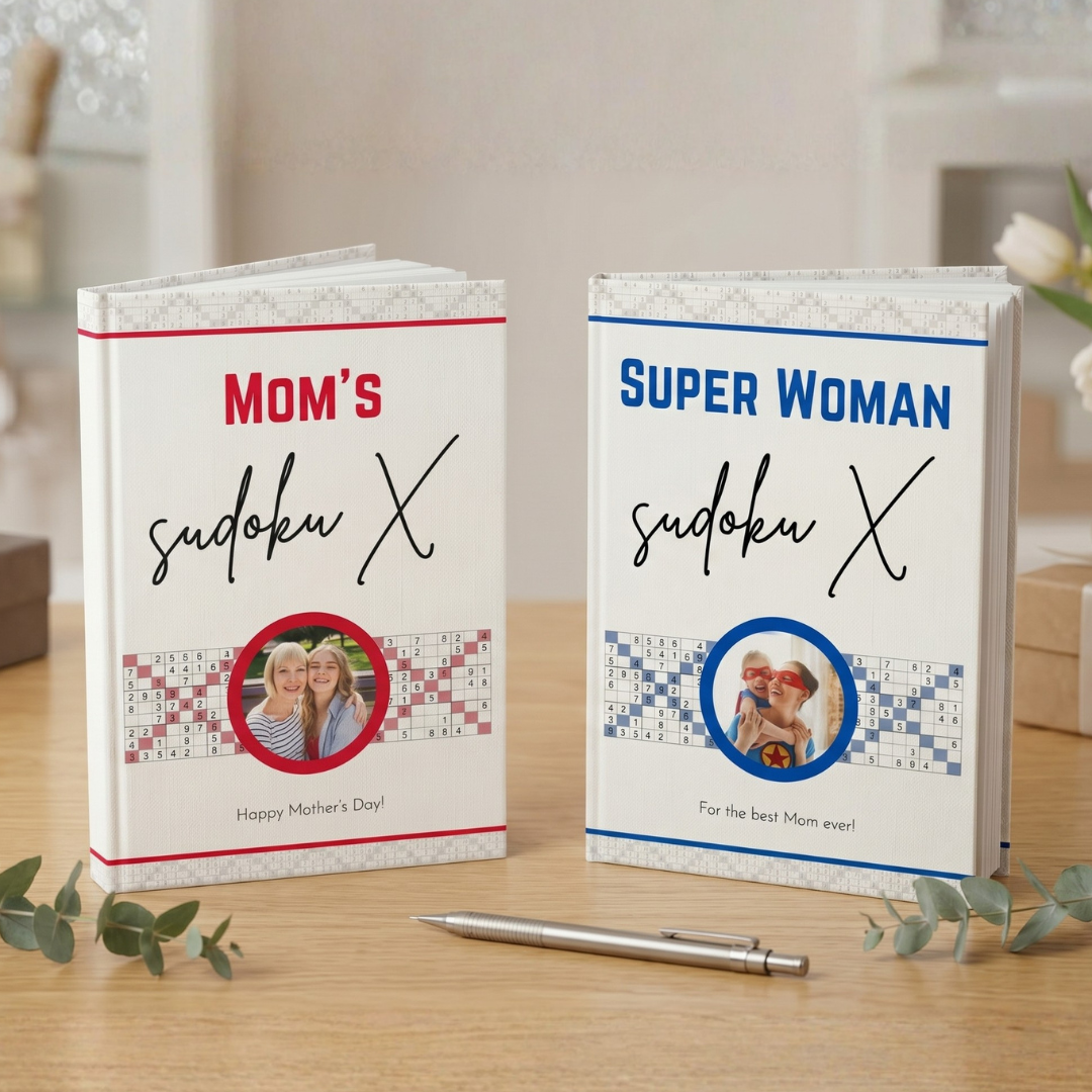 Two Sudoku books titled 'Mom's Sudoku X' and 'Super Woman Sudoku X' on a wooden surface.