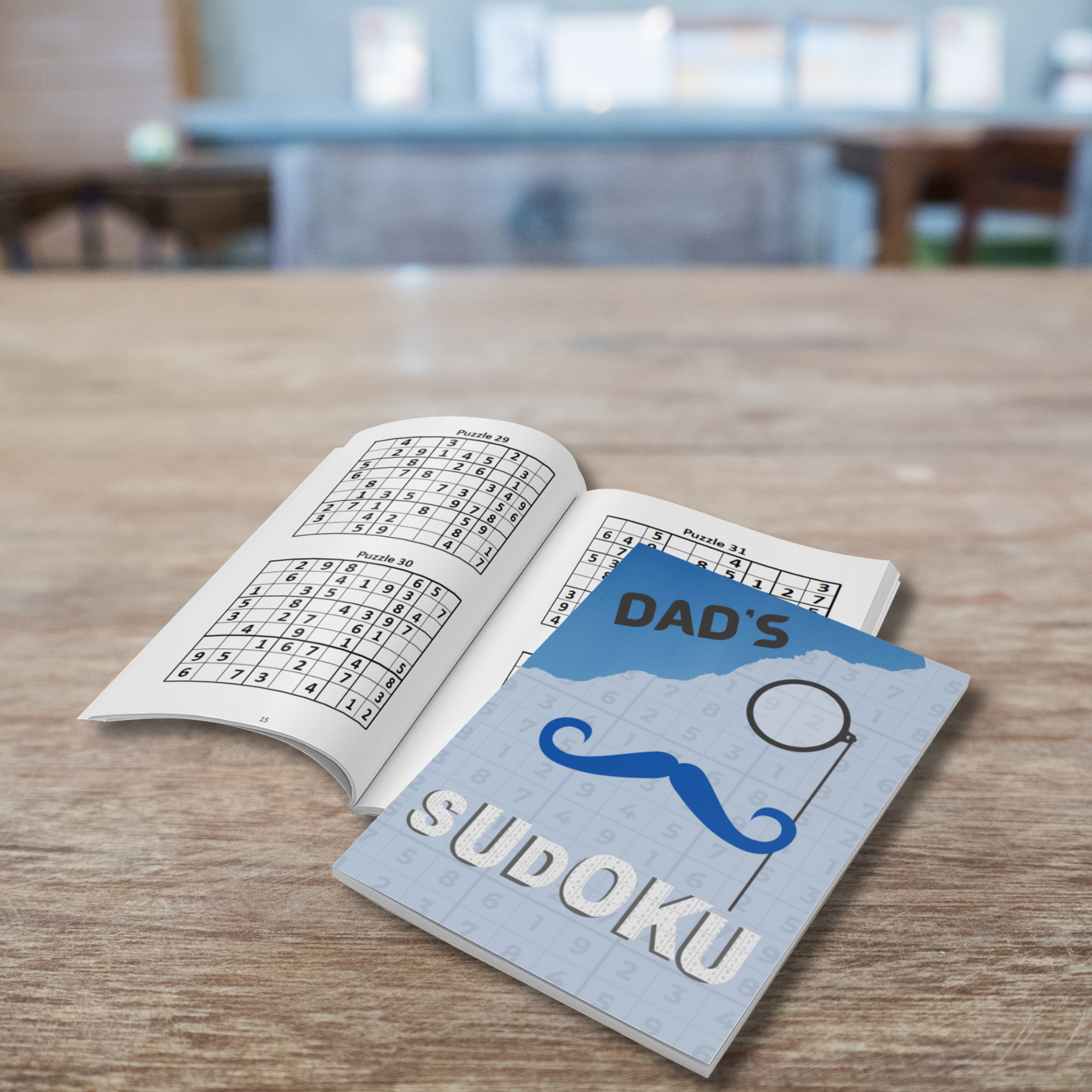 Sudoku book titled 'Dad's Sudoku' on a wooden table showing the interior of the book with sudokus