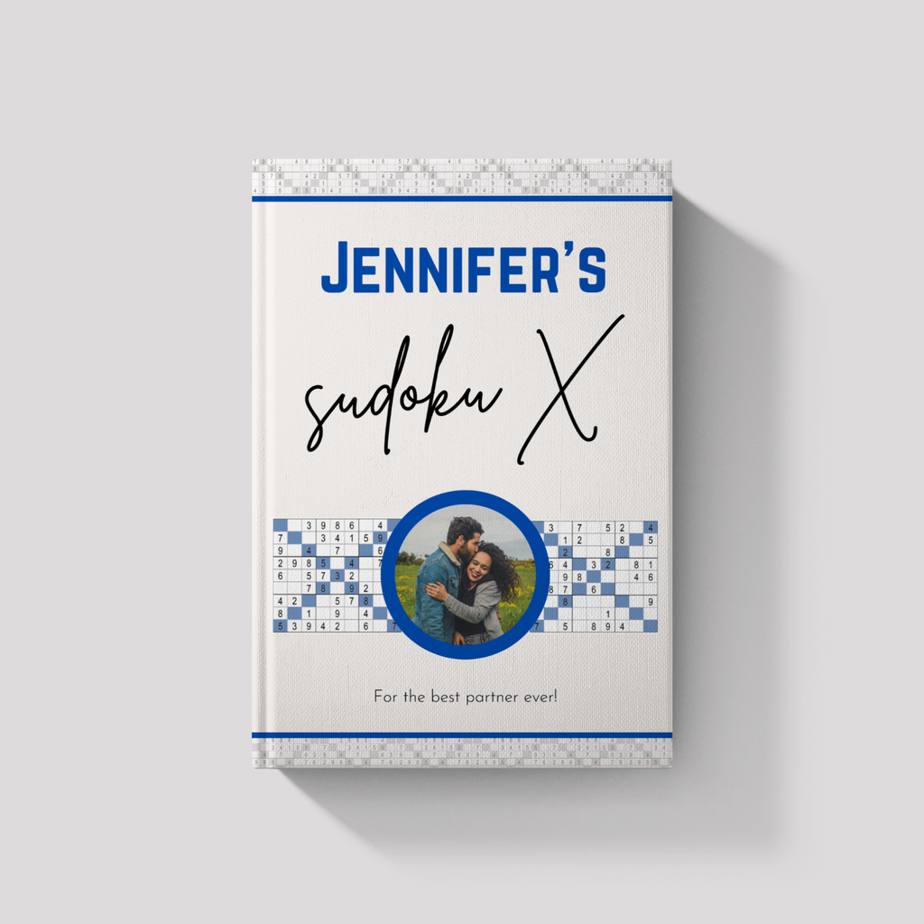 Custom Sudoku X gift book with personalized name and message; the cover features a unique 'XOX' design where a custom couple's photo forms the center letter, shown on a light gray background.