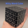 Black Witty Word Cube held in a hand with a gray background