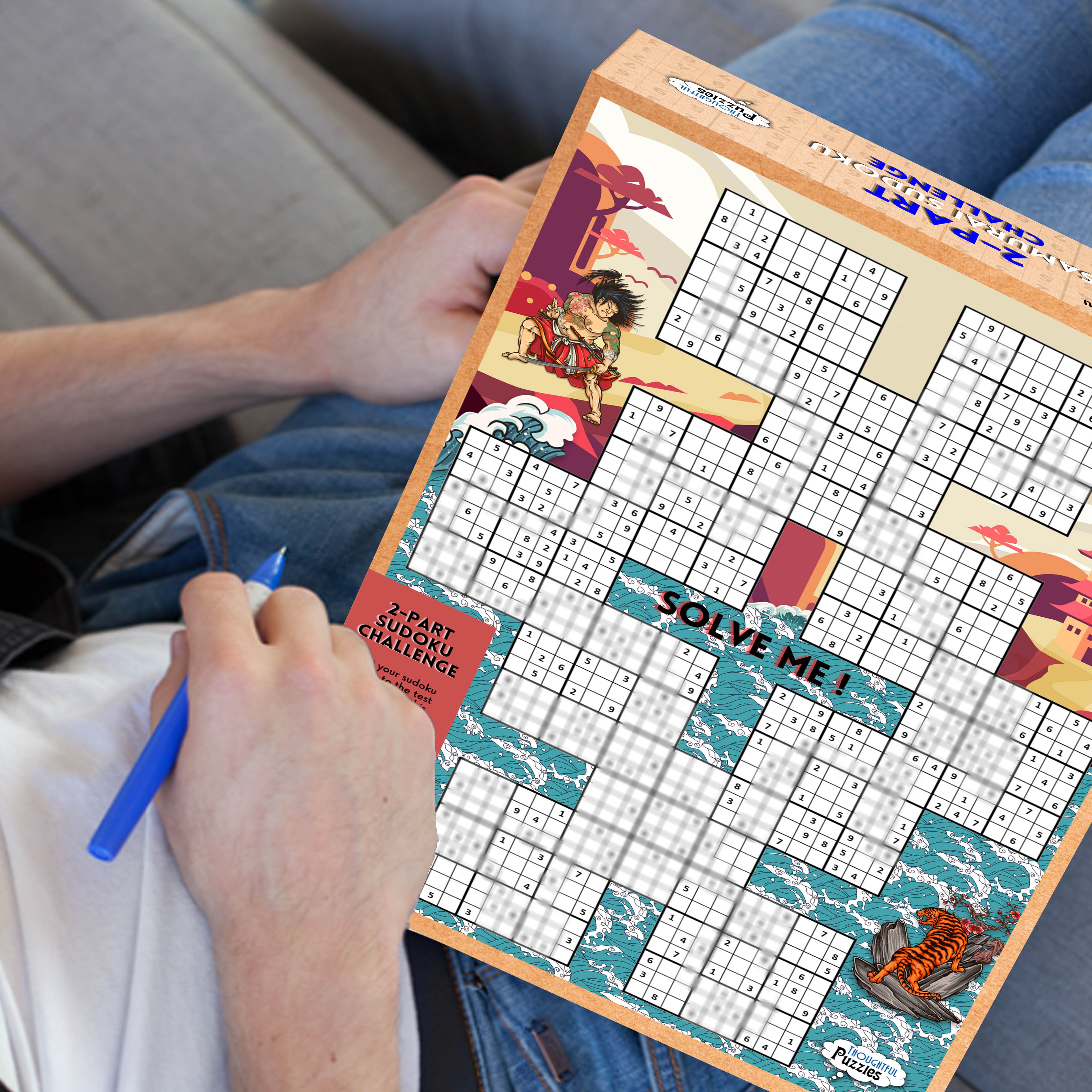 Man with the jigsaw box on his lap completeing part one of samuari sudoku game